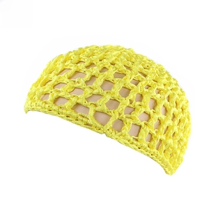 Close-up of handmade yellow crochet hair net with a honeycomb mesh design on a model
