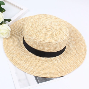 Flat top natural straw boater hat with black ribbon decoration on white background