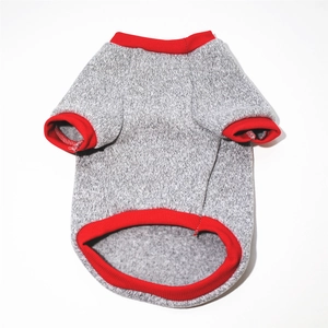 Close-up of grey knit dog sweater with red ribbed edges and warm fleece lining
