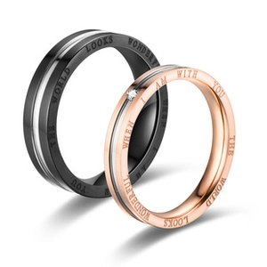 Macro detail of couple rings engraved with The World Looks Wonderful When I Am With You