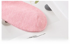Macro detail of fine-stitched toe seam on soft pink cotton low-cut ankle socks
