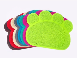 Macro detail of multi-color paw-shaped PVC cat litter mats with non-slip coil texture