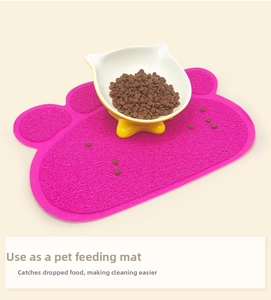 Pink cat paw shaped PVC litter mat with non-slip fiber texture and pet food bowl