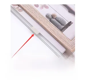 Detail of Nordic iron photo frame showing glass securing clips and wood texture finish