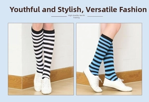 Detail of striped knee-high cotton socks in black, white and blue colors with sneakers