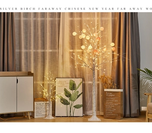 Detail of warm LED birch tree lights with colorful cotton balls and realistic bark texture