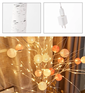 Close-up of artificial birch tree lamp with warm woven balls and power adapter details
