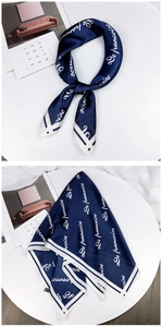 Navy blue silk square scarf with white script lettering and a stylish tied necktie detail
