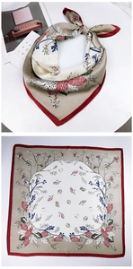 Detail of square silk scarf featuring shell and coral patterns with red rolled edges