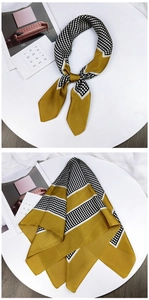Detailed close-up of retro polka dot silk scarf featuring mustard yellow color blocks