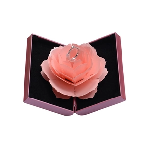 Detail of creative pop-up rotating pink rose flower ring box for wedding proposals
