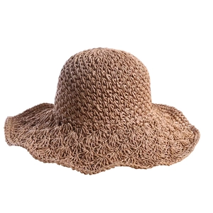 Handwoven caramel straw sun hat with wide wavy brim for summer beach vacation