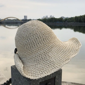 Elegant beige handmade crochet sun hat with wide brim and side button detail