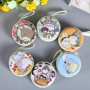 Detailed view of circular Christmas coin purses with Ghibli cartoon patterns and lanyards
