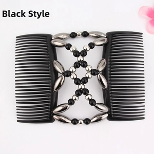Detail of magic hair comb featuring black beads, silver accents and double row teeth