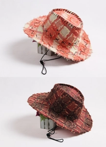 Detail showing the distressed stitching and raw edges of the cowboy hat with chin strap