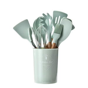 Mint green silicone kitchen utensil set with wooden handles in a matching storage bucket