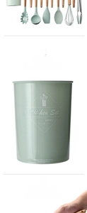 Close-up of mint green silicone utensils with wood handles in a storage bucket