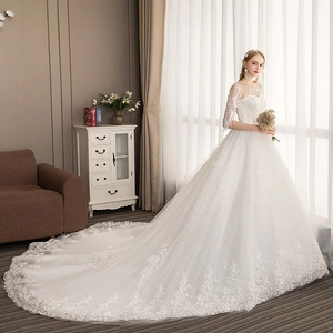 Elegant white lace ball gown wedding dress with off-shoulder neckline and luxury long train
