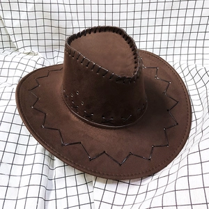 Close-up of brown suede cowboy hat featuring black stitching and metal eyelets
