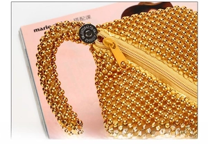 Detail of gold beaded evening bag showing magnetic snap and rustproof hardware