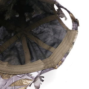 Detail view of camouflage baseball cap showing breathable mesh lining and metal buckle