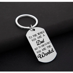 Polished stainless steel Dad keychain with engraved emotional message on black background