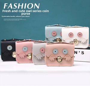 Colorful collection of owl mini wallets in various pastel shades with metal twist locks