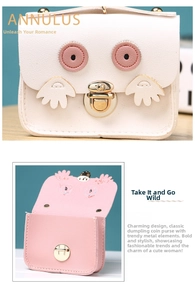 Detail of owl-shaped coin purse featuring metal buckle and pink interior lining