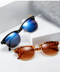 Detail of Clubmaster sunglasses with metallic rivets and classic semi-rimless frames