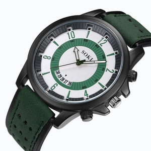 Macro view of SOKI sports watch dial with green face, date window and leather strap