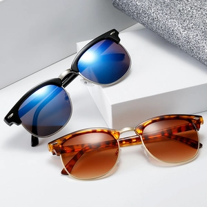 Classic clubmaster sunglasses with vintage half-frame design in black and tortoise finish
