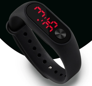 Detail of black LED digital sports watch featuring bright red time display and silicone strap