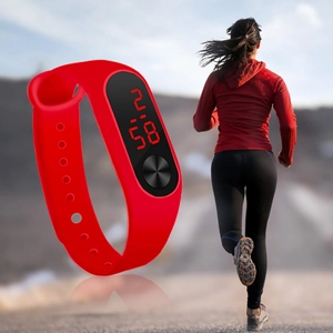 Detail of red silicone LED sports watch with digital red light display and touch button