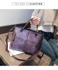 Detail of vintage purple tote bag featuring textured faux leather and decorative front zippers