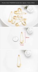 Detail of 39mm golden safety pin charm for DIY jewelry with size comparison to a coin