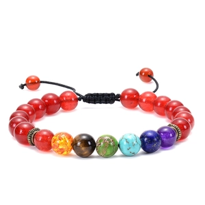 Detail of seven chakra natural stone beads on an adjustable black braided cord bracelet