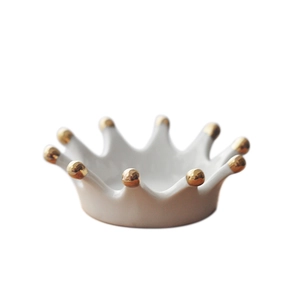 Nordic white ceramic crown jewelry tray with gold accents on a clean white background