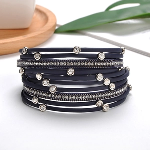 Close-up of multilayer navy blue leather bracelet with sparkling diamond-set metal chains