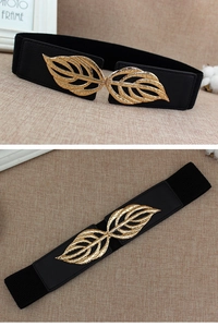 Detail of black elastic belt with golden hollowed leaf metal buckle for dresses