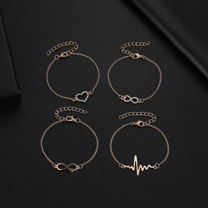 Minimalist 4-piece gold bracelet set featuring heart, infinity, and heartbeat charms