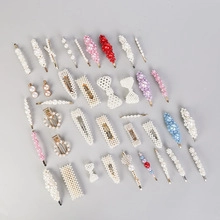 Detailed flat lay of a 40-piece pearl and rhinestone hair clip set on a grey backdrop