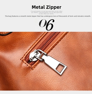 Close-up of smooth silver metal zipper on vintage brown leather boston handbag detail