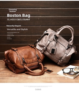 Close-up of caramel brown and beige leather boston bags with premium metal hardware