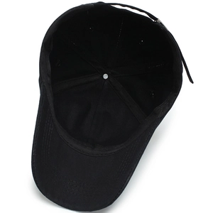 Internal structure of a black cotton baseball cap showing seams and metal buckle