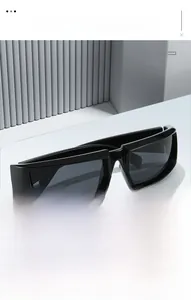 Close-up of black wrap-around frame cycling sunglasses on a white geometric stand