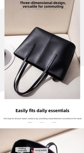 Detailed view of large black leather tote bag capacity with folding umbrella and wallet