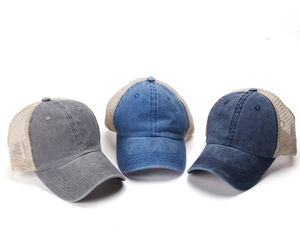 Detailed texture of washed cotton and breathable mesh on vintage trucker hats