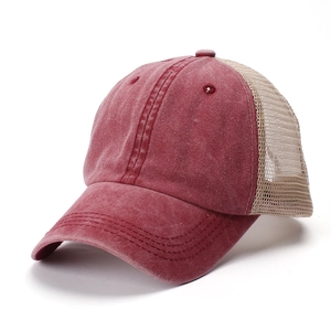 Detail of vintage washed cotton trucker hat with burgundy front and breathable mesh back
