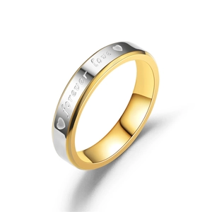 Close-up of gold and silver couple ring featuring Forever Love engraving and heart motif